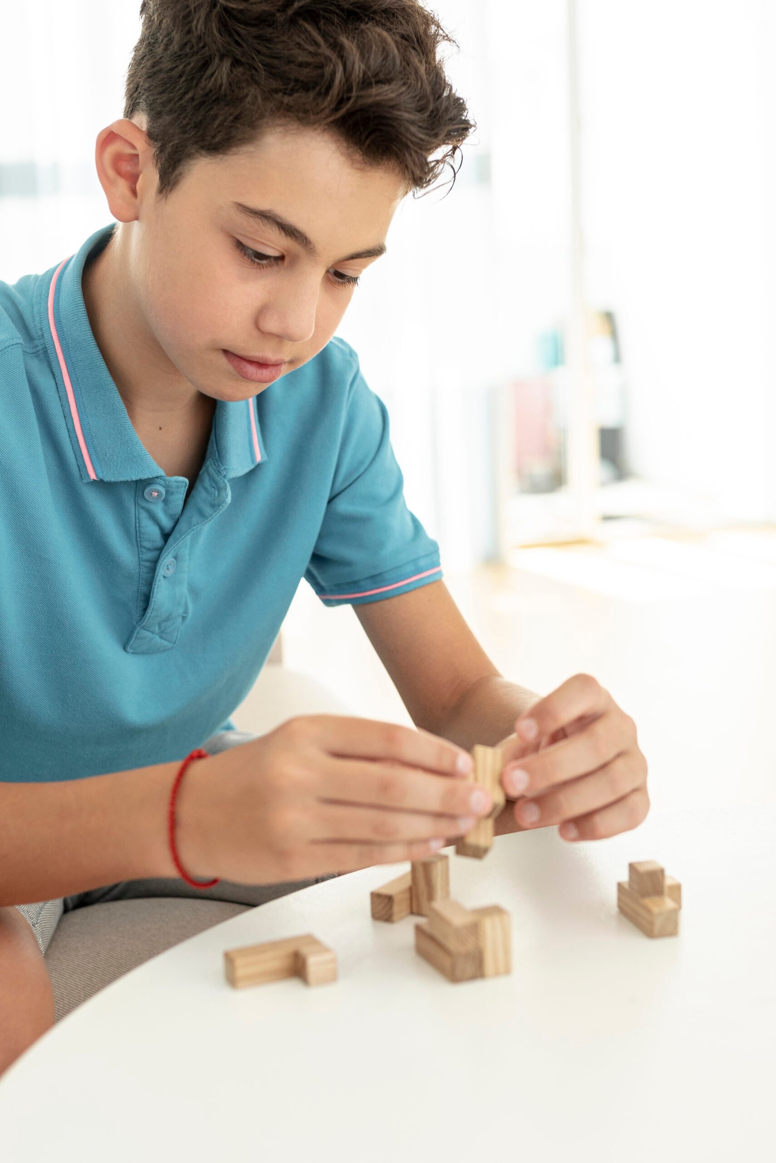 close-up-kid-playing-with-jenga-pieces
